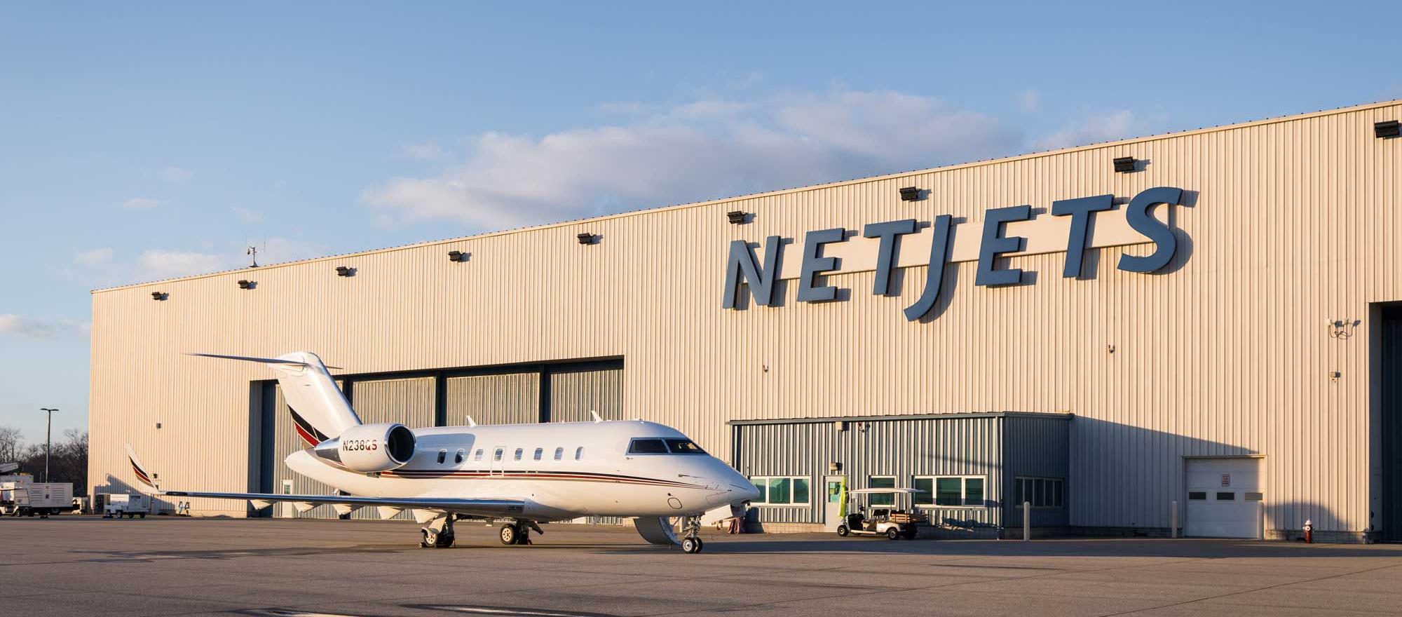 NetJets facility and Challenger 650 parked outside hangar