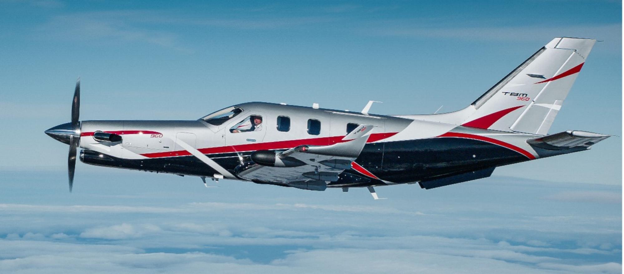 Daher TBM 960 with Sirocco paint scheme in silver and black with red accent stripes in flight