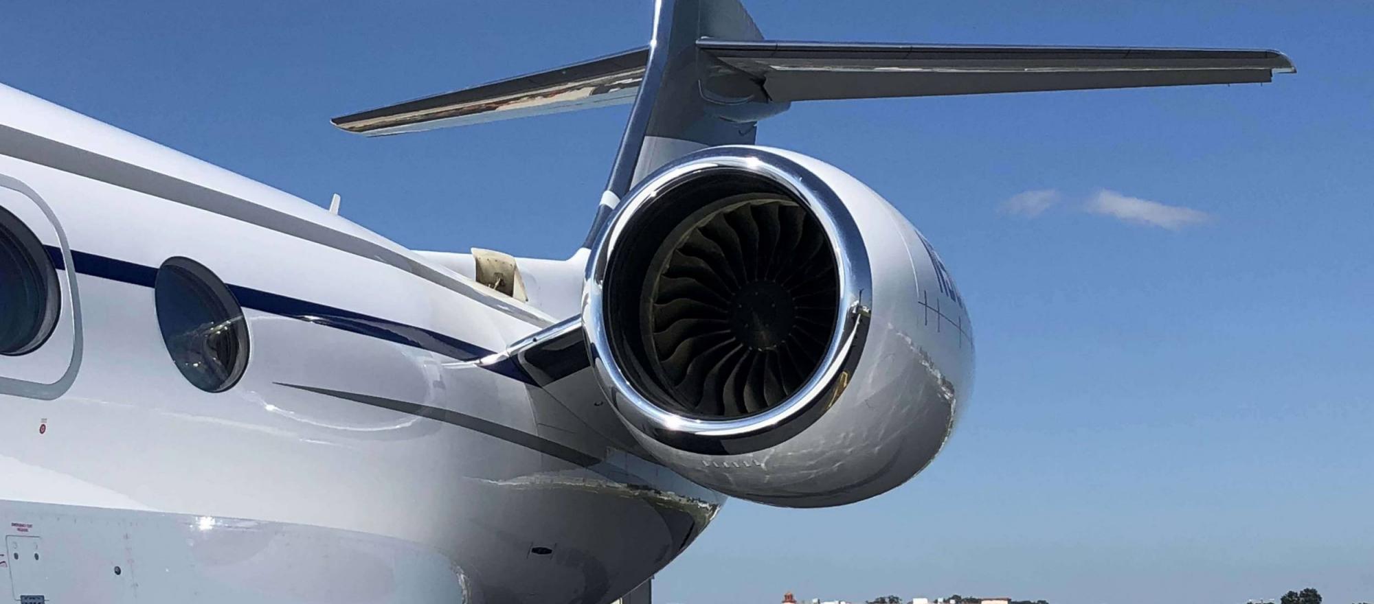 side of business jet looking toward engine and tail