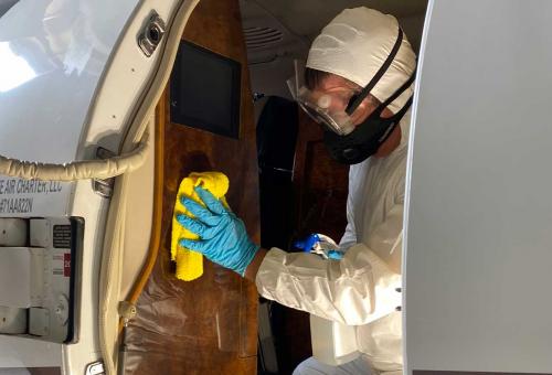 Worker disinfecting aircraft