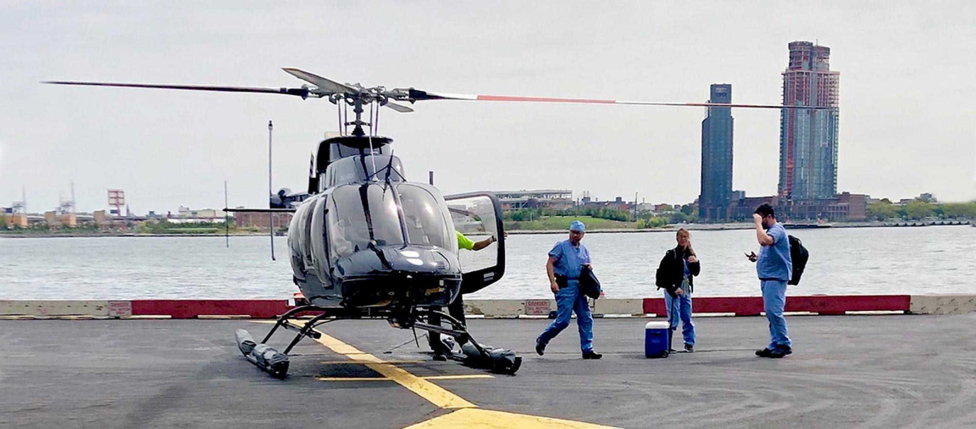 Blade MediMobility helicopter on helipad with organ transport team