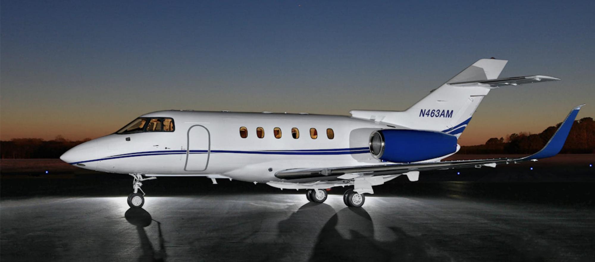 Hawker 800XP operated by Executive Airlink parked on airport ramp at sunset