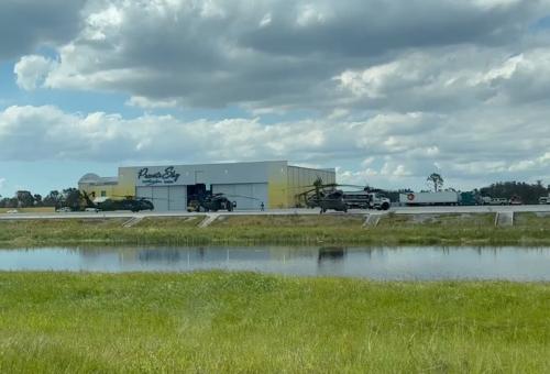 PrivateSky Aviation's ramp at KRSW with military helicopters and flooding seen in ditches
