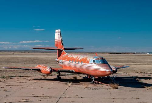 Lockheed JetStar once owned by Elvis Presley parked on overgrown airport ramp in the New Mexico desert