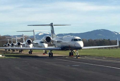 business jets lined up on ramp